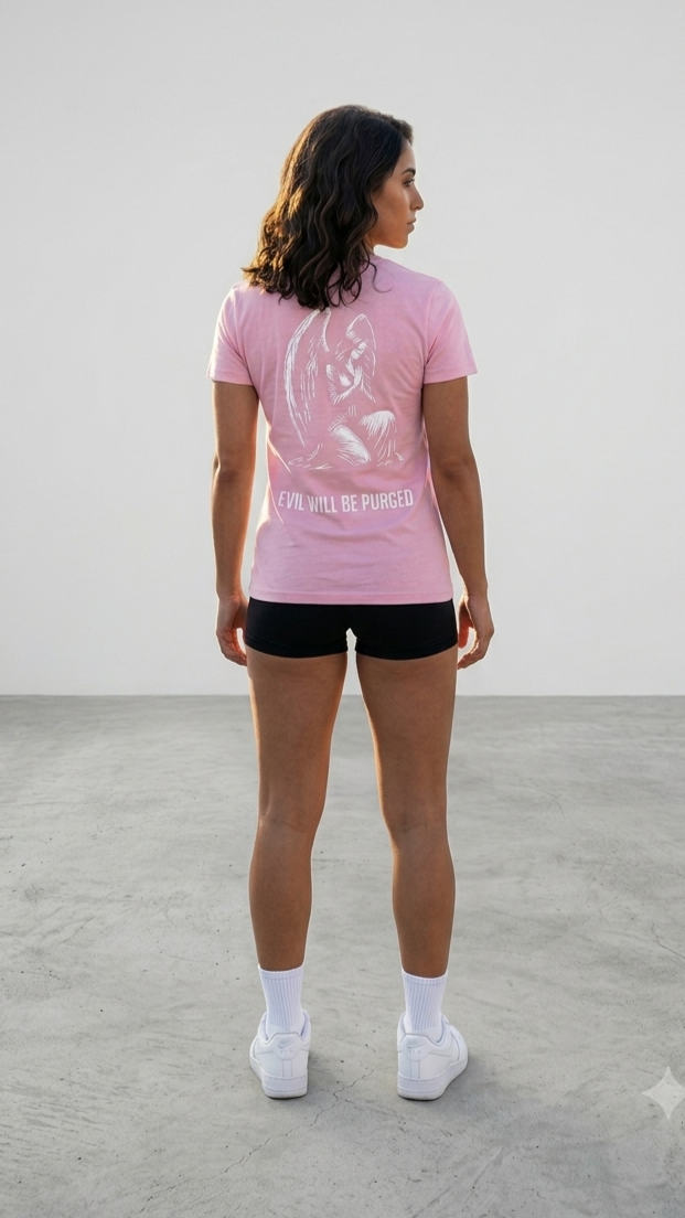 A woman is shown from behind wearing a light pink athletic t-shirt with a white graphic and the text EVIL WILL BE PURGED' on the back, paired with black athletic shorts, white socks, and white sneakers in a minimalist studio setting.