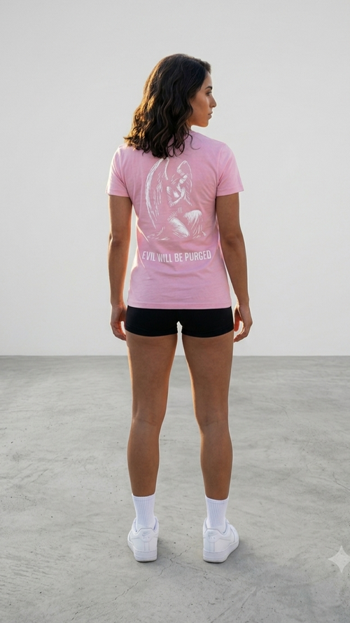 A woman is shown from behind wearing a light pink athletic t-shirt with a white graphic and the text EVIL WILL BE PURGED' on the back, paired with black athletic shorts, white socks, and white sneakers in a minimalist studio setting.
