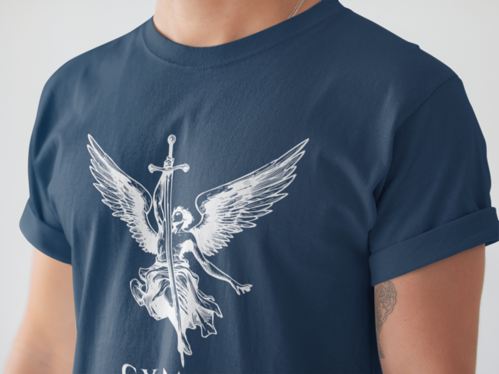 A close-up of a person wearing a navy blue t-shirt with a white graphic of an angel with wings and a sword, holding a banner that reads GYMPOP