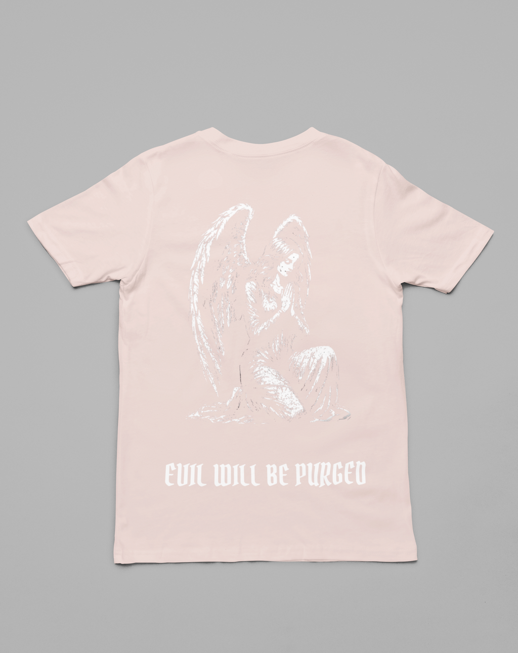 A light pink short-sleeve t-shirt shown from the back, featuring a white line-art graphic of a kneeling angel and the text 'EVIL WILL BE PURGED' printed below it, set against a solid gray background.