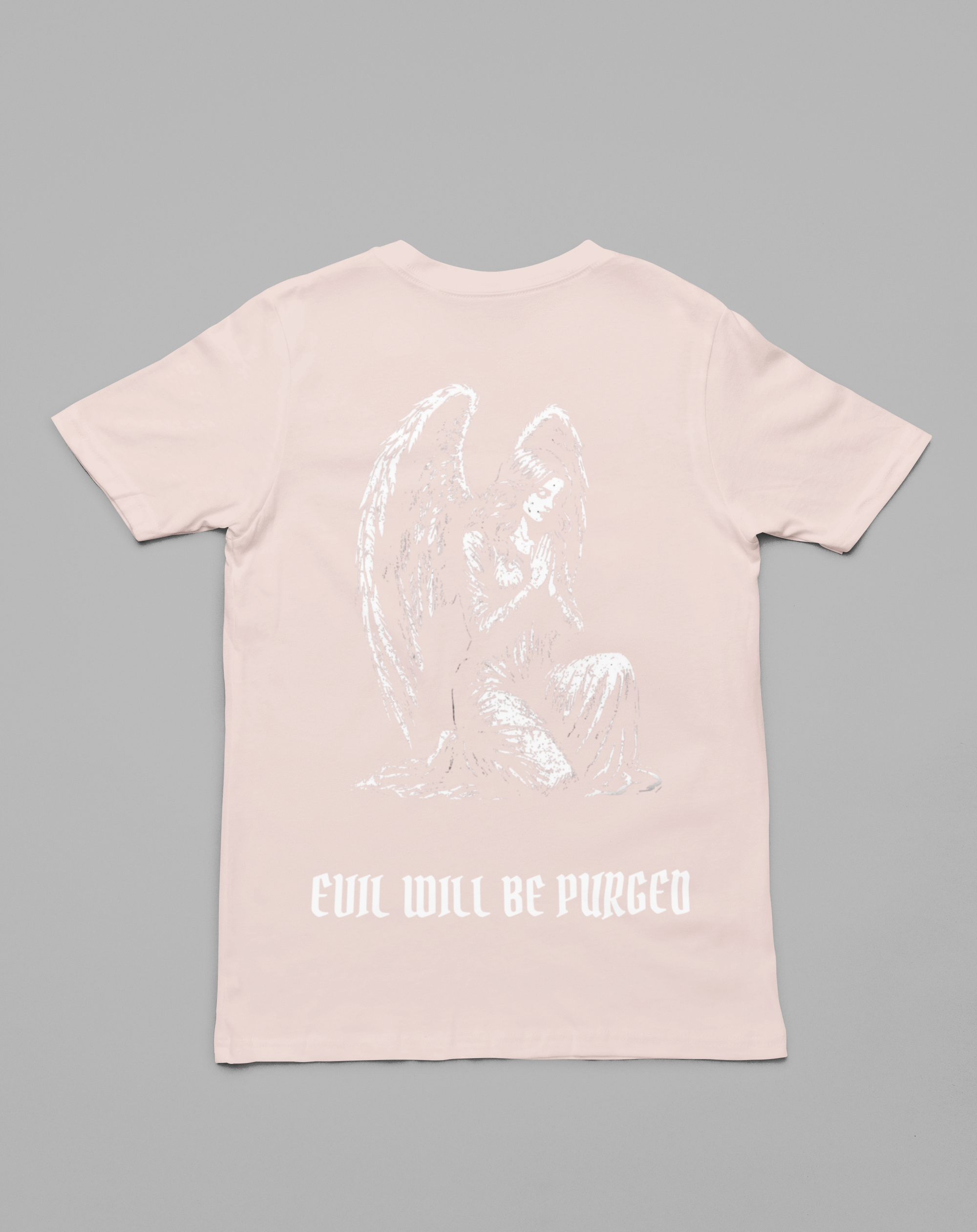 A light pink short-sleeve t-shirt shown from the back, featuring a white line-art graphic of a kneeling angel and the text 'EVIL WILL BE PURGED' printed below it, set against a solid gray background.
