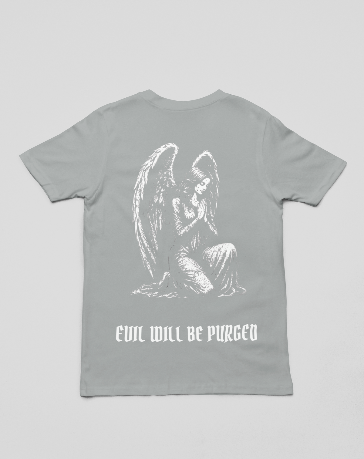 A light gray short-sleeve t-shirt with a white graphic of a kneeling angel and the text 'EVIL WILL BE PURGED' printed on the front, shown against a neutral gray background.