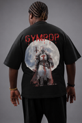 A person shown from the back wearing a black oversized T-shirt with a large graphic print on the back. The shirt features the word 'GYMROP' in red above a circular illustration of a fantasy templar knight figure.