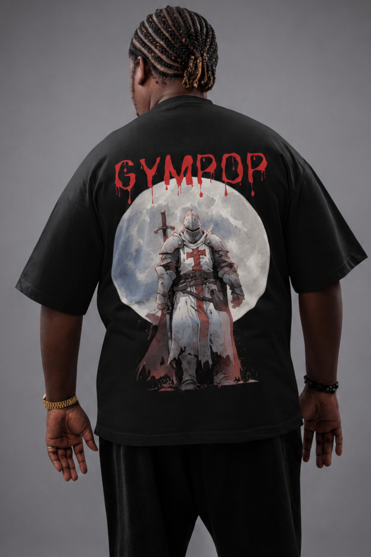 A person shown from the back wearing a black oversized T-shirt with a large graphic print on the back. The shirt features the word 'GYMROP' in red above a circular illustration of a fantasy templar knight figure.