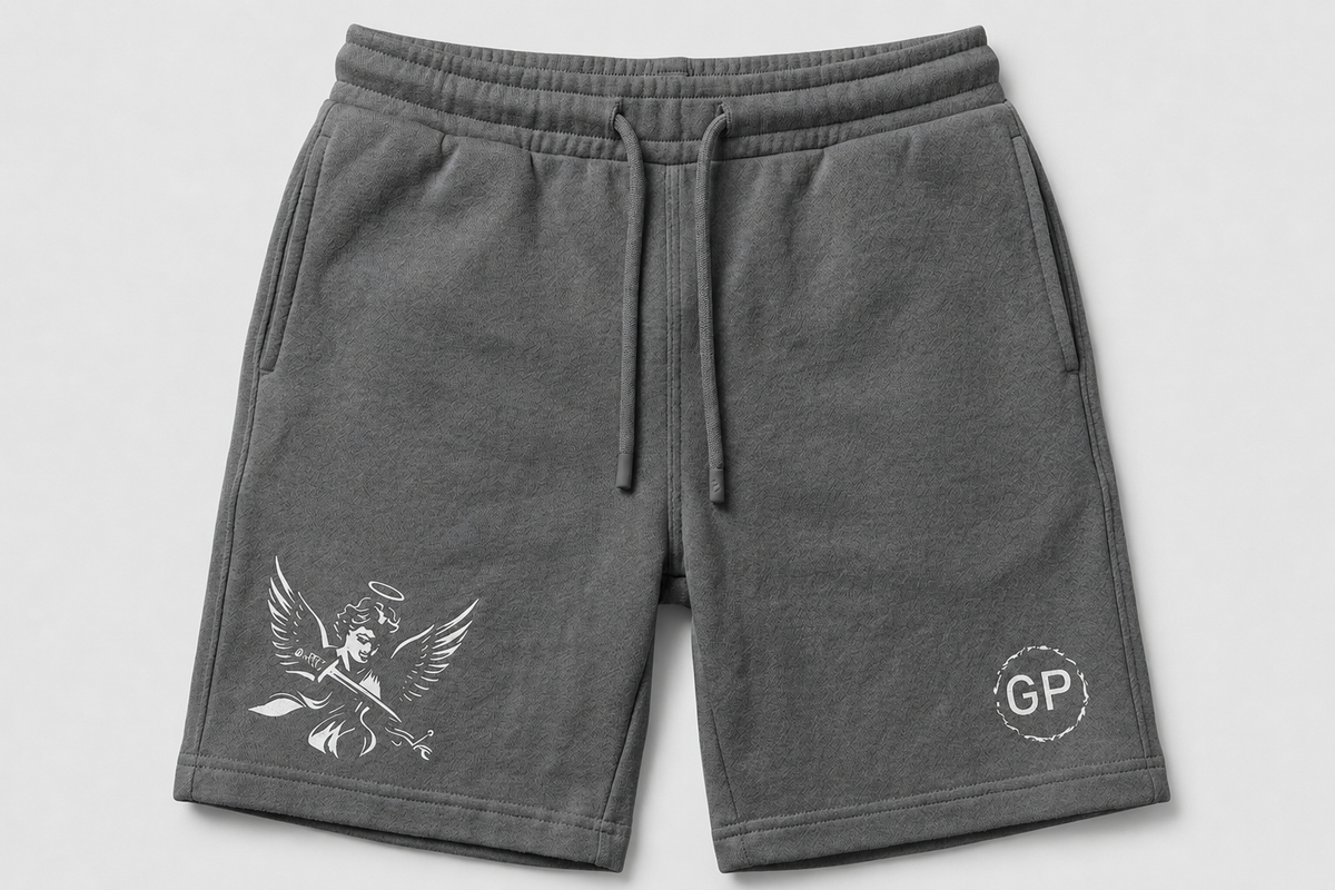 Dark gray sweat shorts with a white angel graphic on the left leg and a circular 'GP' logo on the right leg, shown against a light gray background.