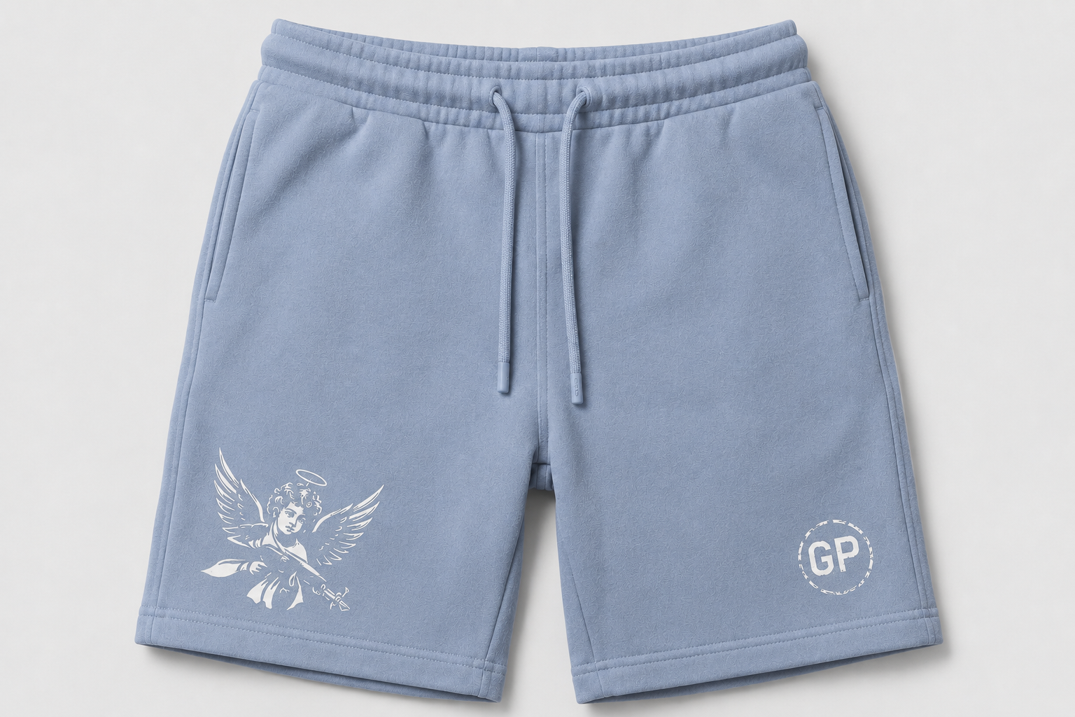 Light blue sweat shorts with a white angel graphic on the left leg and a circular 'GP' logo on the right leg, shown flat on a light gray background.