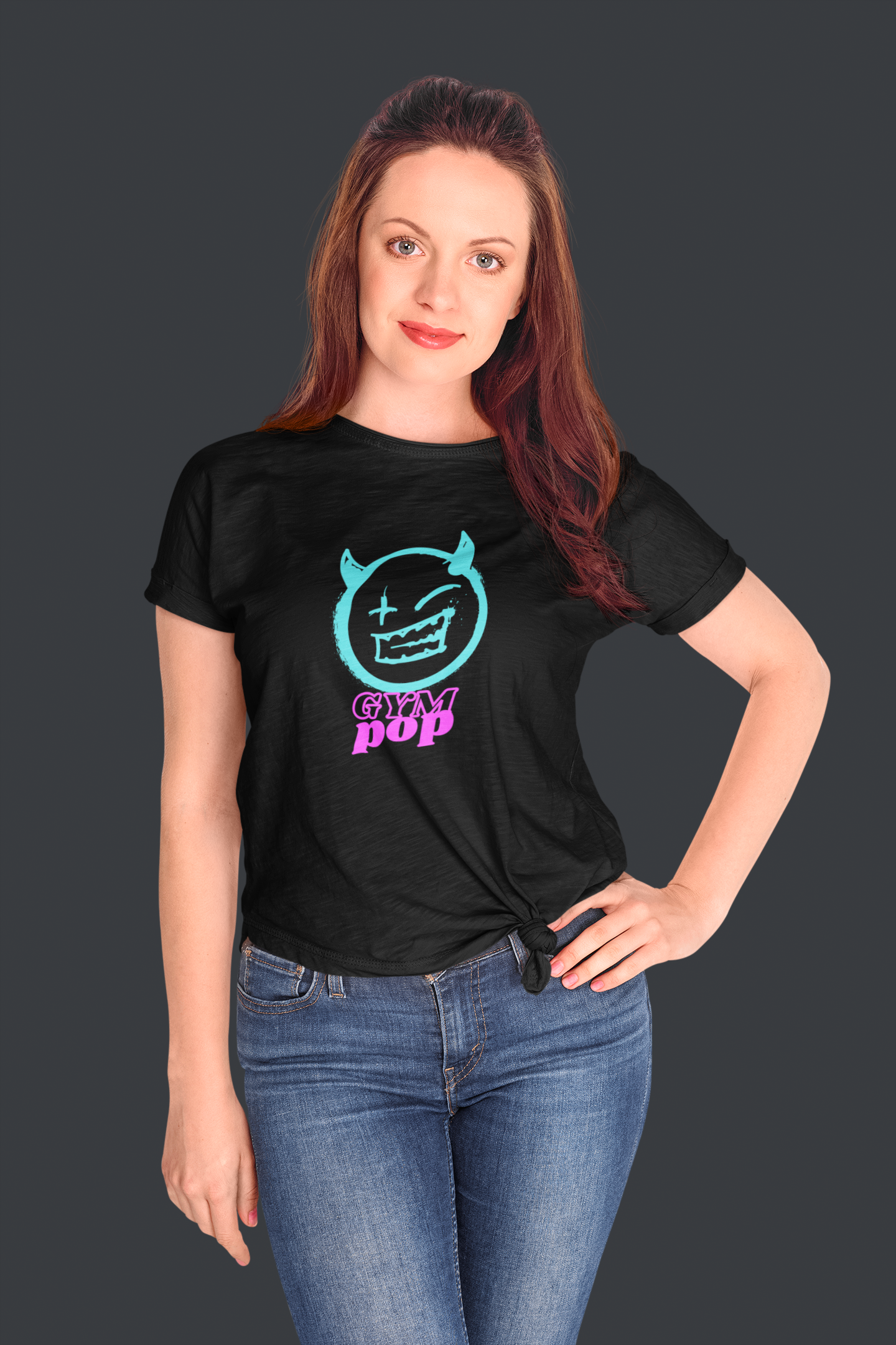 Woman wearing a knotted Neon Devil Signature Tee by Gympop, styled casually in a studio setting.