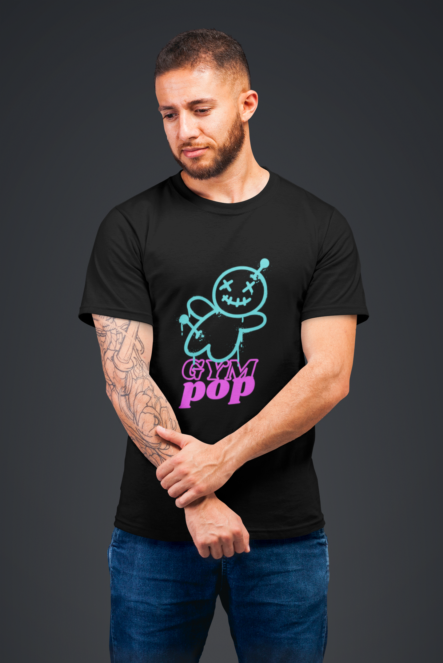 Redhead man wearing Graffiti Voodoo Signature tee by Gympop, standing thoughtfully in a studio setting.